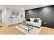 Stylish living room features a modern wet bar, sleek coffee table, and decorative accent wall at 2827 Bellaire St, Denver, CO 80207