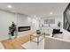 Bright living room with a modern fireplace, wet bar, and stylish seating area at 2827 Bellaire St, Denver, CO 80207