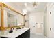 Bathroom featuring double sinks, a large mirror, and sleek black and white tiling at 1433 Olive St, Denver, CO 80220