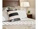 Comfortable bedroom with patterned pillows, a bedside table and lamp at 1433 Olive St, Denver, CO 80220