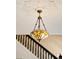 Elegant stained-glass chandelier illuminating a staircase, adding charm and character to the home at 1433 Olive St, Denver, CO 80220