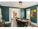 Elegant dining room showcasing dark green walls and views into the living room at 1433 Olive St, Denver, CO 80220