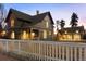 Charming two-story home with a large fenced yard and a detached two-car garage, perfect for Gathering living at 1433 Olive St, Denver, CO 80220