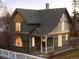 Quaint two-story home showcasing detailed trim work, covered porch and manicured landscaping at 1433 Olive St, Denver, CO 80220