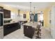 Well-equipped kitchen featuring dark wood cabinets, granite countertops and stainless steel appliances at 1433 Olive St, Denver, CO 80220