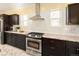 Gourmet kitchen featuring stainless steel appliances, gas range, granite counters, and ample cabinets at 1433 Olive St, Denver, CO 80220