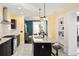 Open kitchen with a large center island with granite countertop and seating for entertaining at 1433 Olive St, Denver, CO 80220