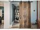 Convenient laundry area with a stacked washer and dryer, and a rustic barn door for added style at 1433 Olive St, Denver, CO 80220