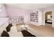 Bright living room boasts chic decor, open shelving, and an open doorway to the main bedroom with soft natural light at 1433 Olive St, Denver, CO 80220