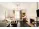 Bright living room with hardwood floors, fireplace, and large windows for plenty of natural light at 1433 Olive St, Denver, CO 80220