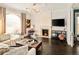Cozy living room with a fireplace, hardwood floors, modern lighting, and comfortable seating for relaxation and entertainment at 1433 Olive St, Denver, CO 80220