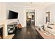 Open-concept living room featuring hardwood floors, a fireplace, and seamless access to the kitchen and dining area at 1433 Olive St, Denver, CO 80220