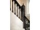 Close up of wooden staircase with decorative details and a window providing natural light at 1433 Olive St, Denver, CO 80220