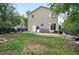 Spacious backyard with patio, lush lawn, and mature trees, perfect for outdoor activities at 1419 Swan Ave, Brighton, CO 80601