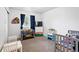 Well-lit bedroom, showcasing a comfortable crib, toys, and a functional changing station at 1419 Swan Ave, Brighton, CO 80601