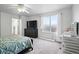 Bedroom featuring large window for natural light and white trim at 1419 Swan Ave, Brighton, CO 80601