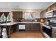 Kitchen showcasing tile backsplash, stainless oven, matching cabinets and granite counters at 1419 Swan Ave, Brighton, CO 80601