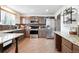 Well lit kitchen features stainless appliances, wood floors, and granite countertops at 1419 Swan Ave, Brighton, CO 80601
