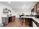 Open kitchen featuring granite countertops, wood floors, and dining area at 1419 Swan Ave, Brighton, CO 80601