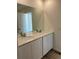 Bathroom featuring double sinks with chrome faucets, a large mirror, and a clean, white color scheme at 21966 E 39Th Pl, Aurora, CO 80019