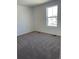 Bright, carpeted bedroom with a large window providing ample natural light, ready for personalization and comfort at 21966 E 39Th Pl, Aurora, CO 80019
