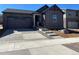 Charming home featuring stone accents, a two-car garage, and newly landscaped front yard with a concrete driveway at 21966 E 39Th Pl, Aurora, CO 80019