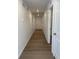 Bright hallway with hardwood floors, recessed lighting, and white walls, leading to various rooms in the home at 21966 E 39Th Pl, Aurora, CO 80019