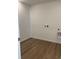 Functional laundry room with wood-look flooring and connections for a washer and dryer at 21966 E 39Th Pl, Aurora, CO 80019