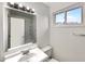 Bathroom featuring a window, a mirror, a white sink, and a toilet at 9976 Appletree Pl, Thornton, CO 80260