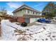 Two-story home with attached garages, brick accents, and siding under a blue sky at 9976 Appletree Pl, Thornton, CO 80260