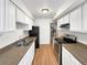 Kitchen with stainless steel appliances, black refrigerator, and white cabinets at 9976 Appletree Pl, Thornton, CO 80260