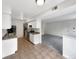 Open kitchen with stainless steel appliances, white cabinetry, and a view into the living area at 9976 Appletree Pl, Thornton, CO 80260