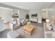 Staged living room with modern furniture, decor, and view of the kitchen at 9976 Appletree Pl, Thornton, CO 80260