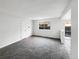 Unfurnished living room featuring neutral carpet, paint, and sliding glass door at 9976 Appletree Pl, Thornton, CO 80260