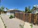 View of the two-car garage and the fenced yard at 1303 Havana St, Aurora, CO 80010