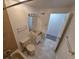 Full bathroom with toilet and vanity and open bathroom doorway at 1303 Havana St, Aurora, CO 80010