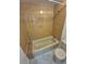 Bathroom features shower and tub combination with ceramic tile surround at 1303 Havana St, Aurora, CO 80010