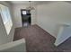 Dining room with neutral carpeting, chandelier lighting, and an adjacent kitchen area at 1303 Havana St, Aurora, CO 80010