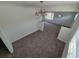 This dining room offers neutral carpeting, overhead lighting, and easy access to other rooms in the home at 1303 Havana St, Aurora, CO 80010