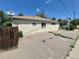 Single story home features windows and a fenced yard at 1303 Havana St, Aurora, CO 80010