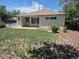 Charming single-story home with quaint front yard with a concrete porch and a secure front door at 1303 Havana St, Aurora, CO 80010