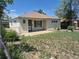 Charming single-story home with quaint front yard with a concrete porch and a fenced yard at 1303 Havana St, Aurora, CO 80010