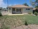 Charming single-story home with quaint front yard with a concrete porch and a secure front door at 1303 Havana St, Aurora, CO 80010
