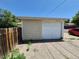 Two-car garage adjacent to the home features a white garage door at 1303 Havana St, Aurora, CO 80010