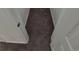 A narrow hallway with neutral carpeting and a doorway leading to other areas of the home at 1303 Havana St, Aurora, CO 80010