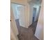 Hallway leading to rooms with neutral carpet and white walls at 1303 Havana St, Aurora, CO 80010