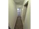 Hallway with carpet flooring leading to a bedroom at 1303 Havana St, Aurora, CO 80010
