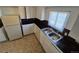 Close up of the kitchen sink, black counters, and stainless steel faucet at 1303 Havana St, Aurora, CO 80010
