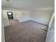 A spacious living room boasts neutral carpeting and ample natural light streaming through the windows at 1303 Havana St, Aurora, CO 80010