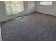 Bright living room featuring large windows, neutral carpeting, and an inviting open layout at 1303 Havana St, Aurora, CO 80010